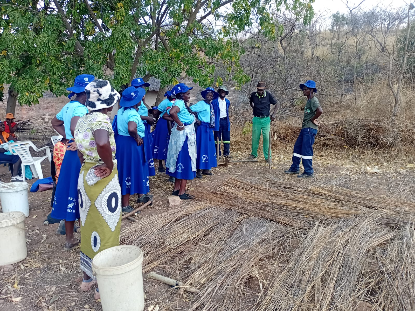 Women farmers in blue uniforms gathered for field training